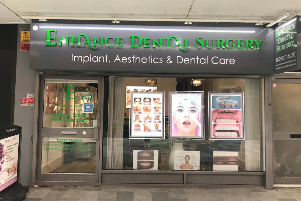 Shopfront of Enhance Dental Surgery on Queens Square, Crawley, signed Implant, Aesthetics and Dental Care