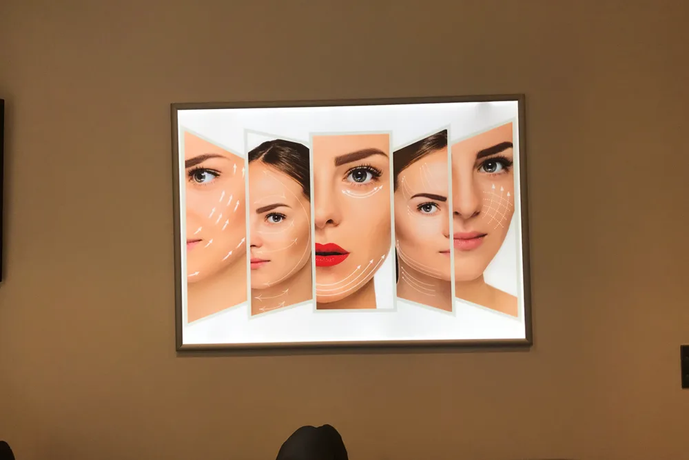 Framed artwork of faces above the reception counter