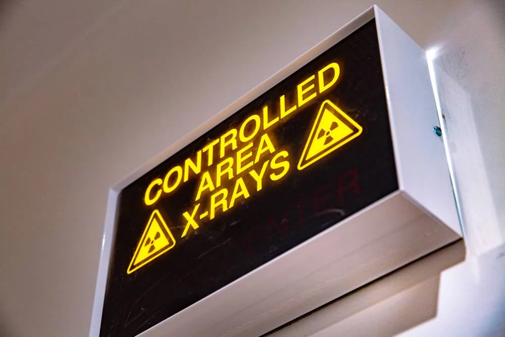 Illuminated X-ray controlled area warning sign in the practice
